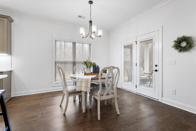 dining space featuring ornamental molding, dark hardwood / wood-style floors, and a chandelier