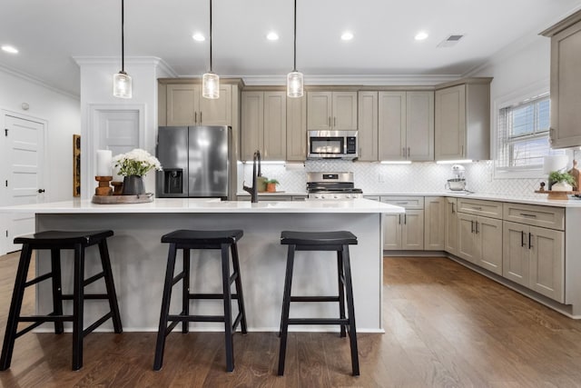 kitchen featuring stainless steel appliances, a kitchen island, and decorative light fixtures