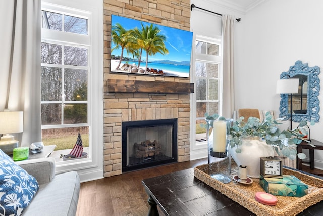 living room featuring a brick fireplace, crown molding, and dark wood-type flooring