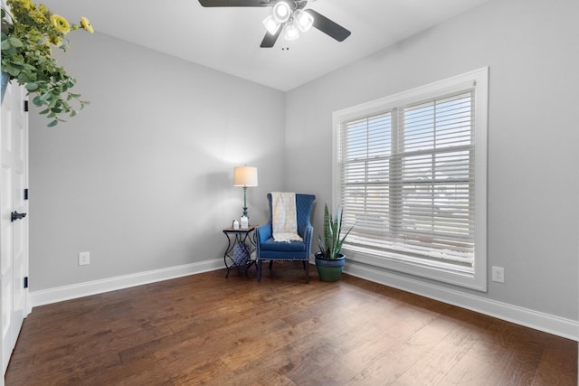 sitting room featuring ceiling fan and dark hardwood / wood-style flooring