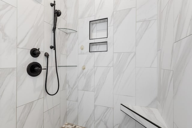 bathroom with tiled shower