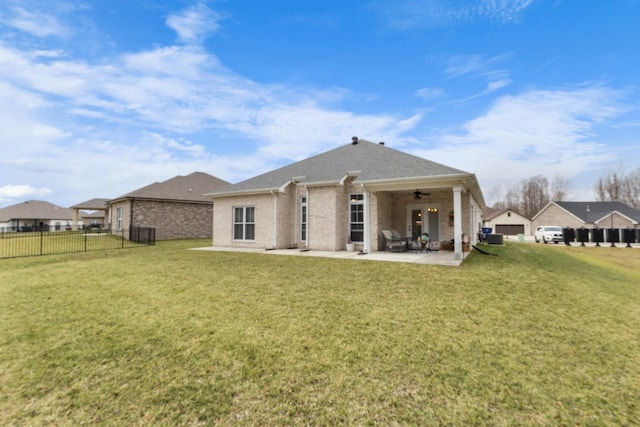 back of house with a lawn, a patio, and ceiling fan