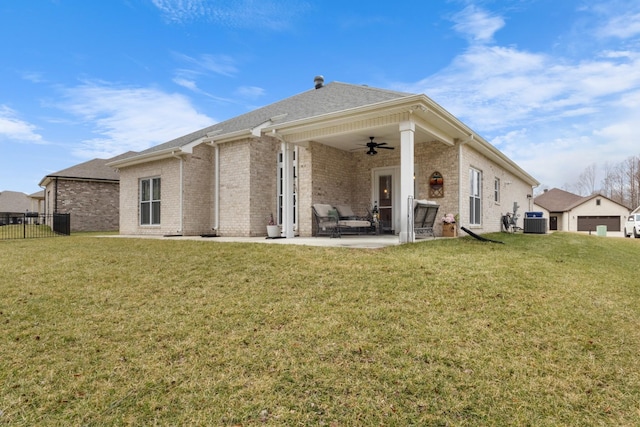 rear view of property featuring central AC unit, a yard, a patio, and ceiling fan