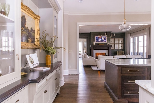 bar featuring white cabinetry, dark hardwood / wood-style floors, dark stone countertops, and decorative light fixtures