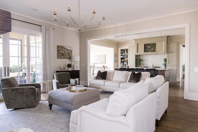 living room featuring ornamental molding, a chandelier, and hardwood / wood-style floors