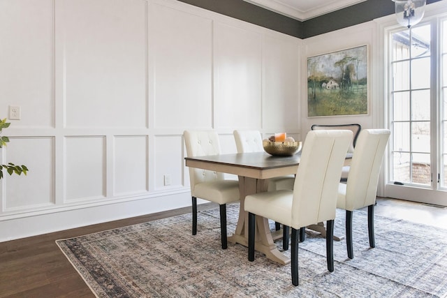 dining room with ornamental molding and dark hardwood / wood-style floors