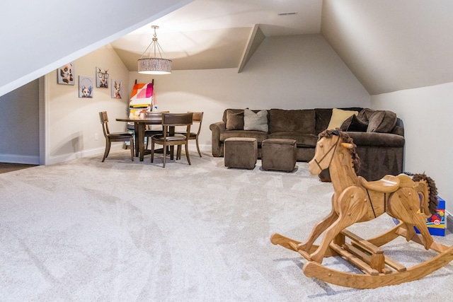 carpeted living room with vaulted ceiling