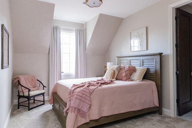 carpeted bedroom featuring multiple windows and vaulted ceiling