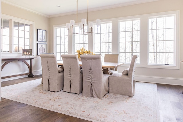 dining space featuring crown molding, a healthy amount of sunlight, and hardwood / wood-style floors