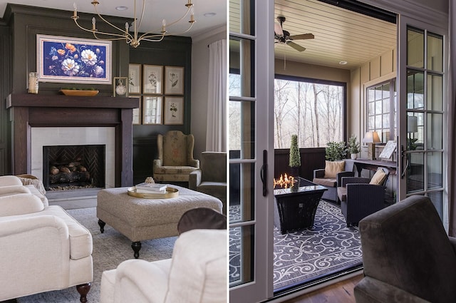 living room with wood-type flooring and ceiling fan with notable chandelier