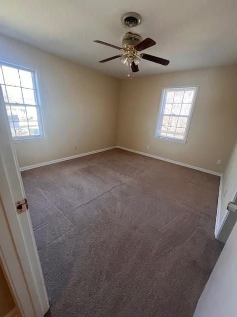 carpeted spare room featuring ceiling fan