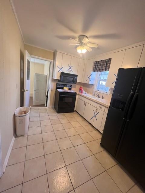 kitchen featuring light tile patterned flooring, white cabinets, ceiling fan, and black appliances