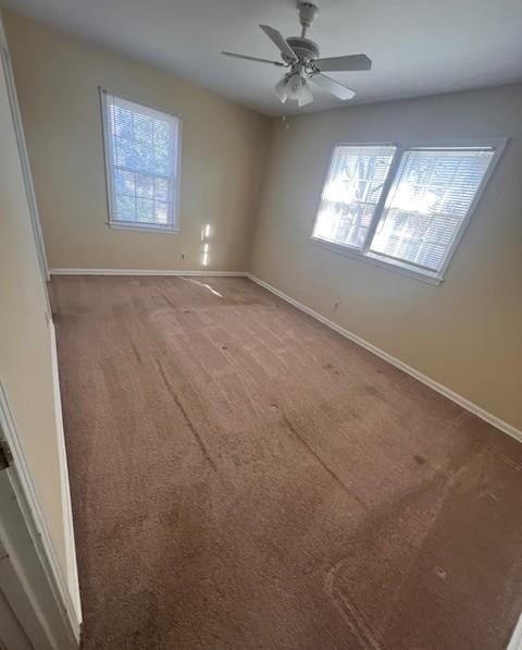 unfurnished room featuring ceiling fan and carpet flooring