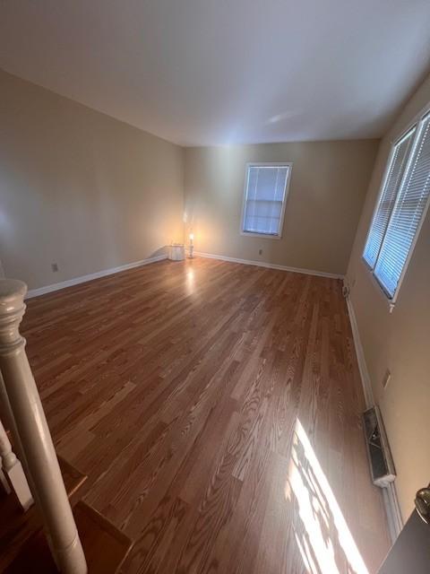 spare room featuring dark wood-type flooring