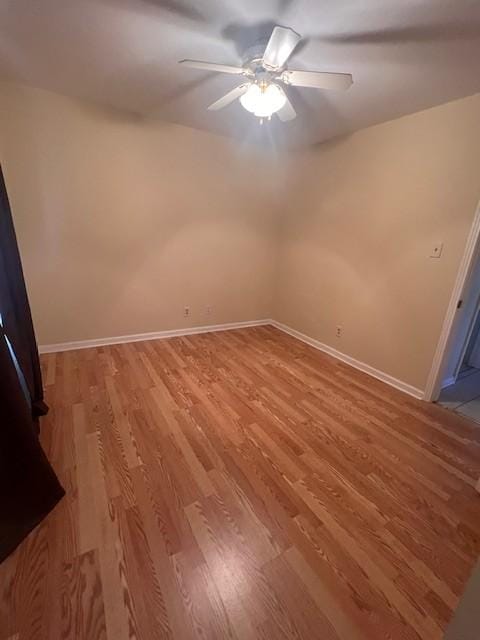 spare room with hardwood / wood-style floors and ceiling fan