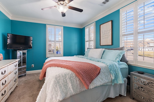 carpeted bedroom featuring multiple windows, ornamental molding, and ceiling fan