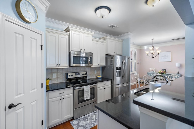 kitchen featuring sink, white cabinetry, stainless steel appliances, tasteful backsplash, and wood-type flooring