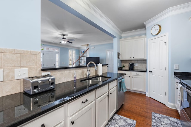 kitchen with sink, white cabinetry, tasteful backsplash, appliances with stainless steel finishes, and dark hardwood / wood-style floors