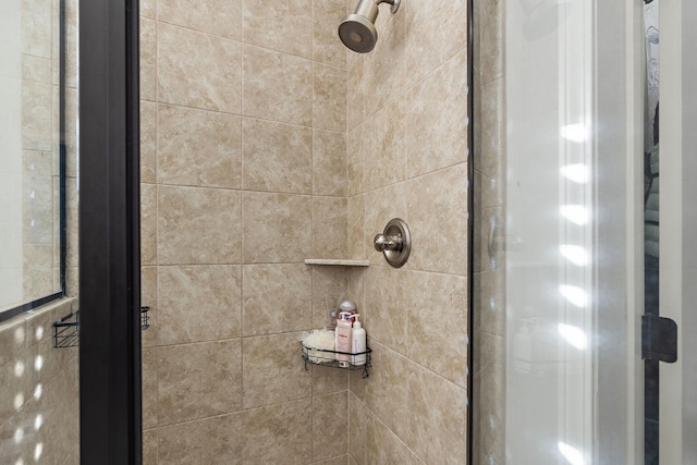 interior details featuring a tile shower