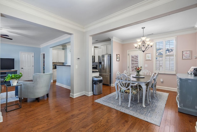 dining room with crown molding, dark hardwood / wood-style floors, and a chandelier