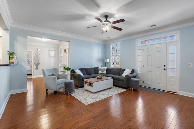 living room with crown molding, wood-type flooring, and ceiling fan