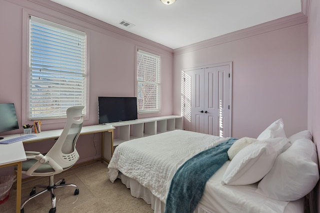 bedroom with multiple windows, ornamental molding, light carpet, and a closet