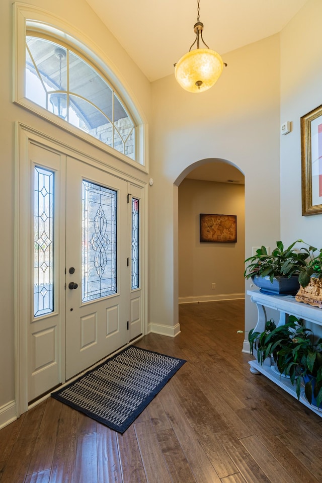 foyer featuring dark hardwood / wood-style floors and a towering ceiling