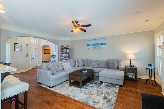 living room featuring crown molding, dark hardwood / wood-style floors, and ceiling fan