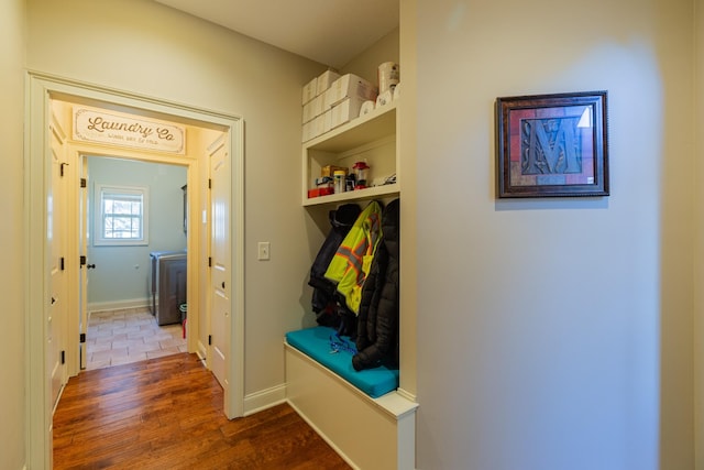 mudroom featuring hardwood / wood-style floors and washer / dryer