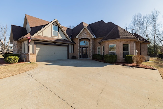 view of front of home with central air condition unit, brick siding, a shingled roof, driveway, and stone siding