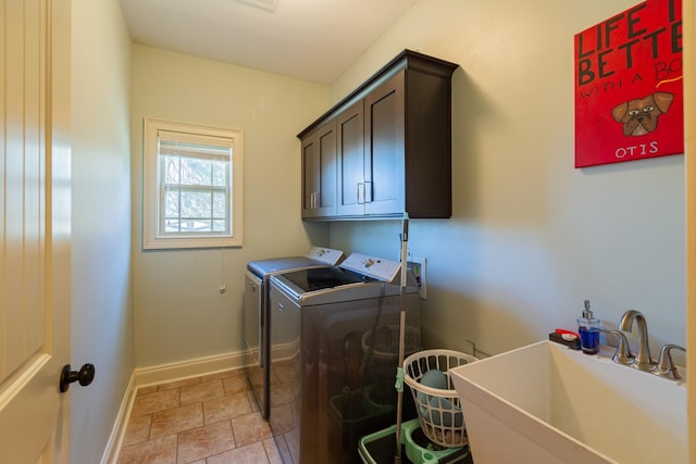 washroom featuring cabinets, sink, and washing machine and clothes dryer