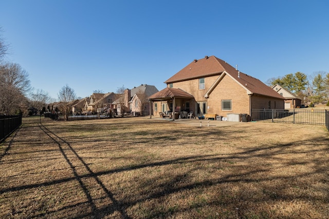 back of house featuring a yard and a patio