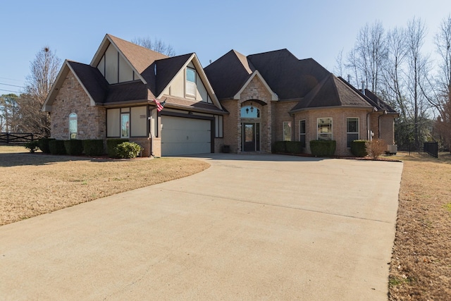 view of front of property with stone siding, concrete driveway, and brick siding