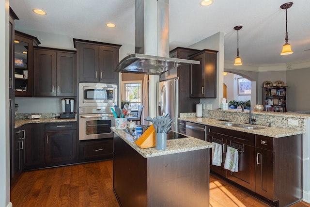 kitchen featuring decorative light fixtures, sink, island exhaust hood, kitchen peninsula, and stainless steel appliances