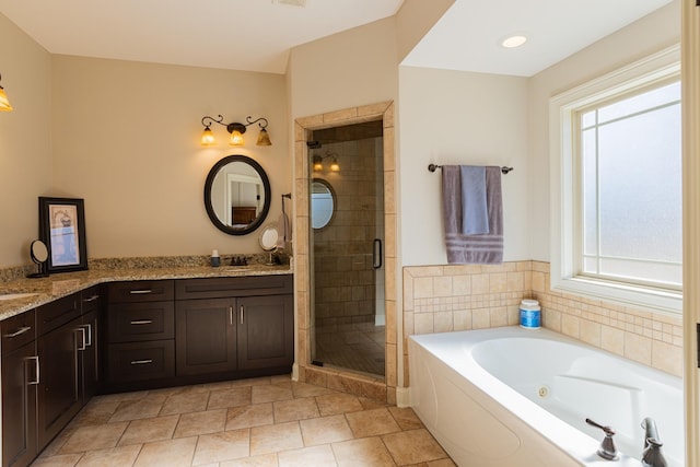 bathroom featuring vanity, tile patterned flooring, and plus walk in shower