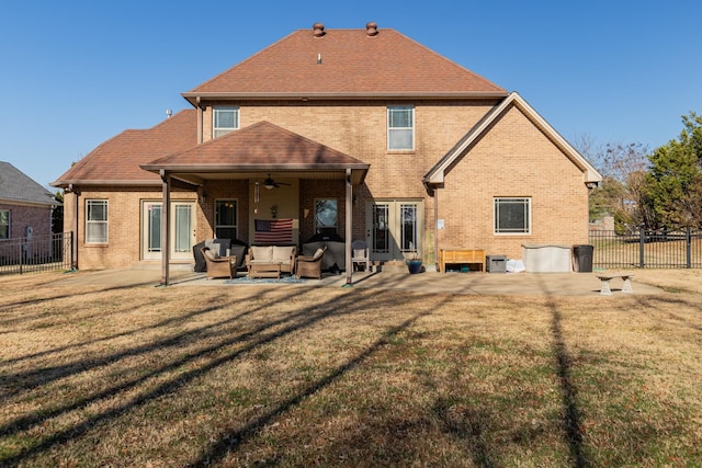 rear view of house featuring outdoor lounge area, a yard, ceiling fan, and a patio area