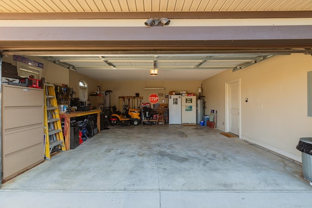 garage with water heater, white fridge, and a workshop area