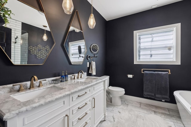 bathroom featuring vanity, a bathtub, and toilet