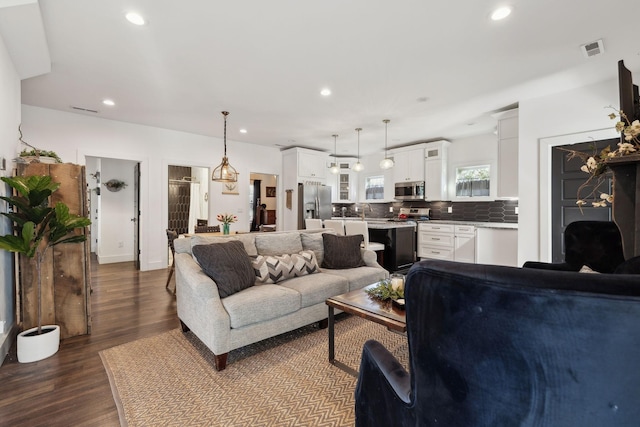 living room featuring hardwood / wood-style flooring and sink