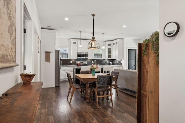 dining area featuring dark hardwood / wood-style flooring and sink