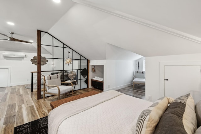 bedroom with lofted ceiling, wood-type flooring, and a wall mounted AC