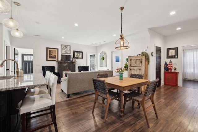 dining area featuring dark hardwood / wood-style floors and sink