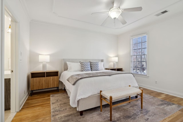 bedroom featuring ceiling fan, ornamental molding, and hardwood / wood-style floors