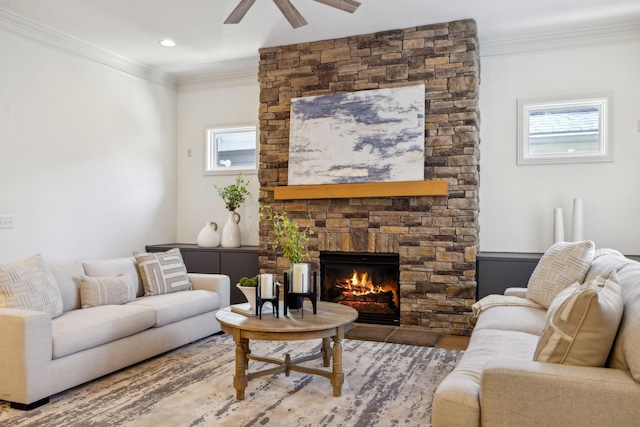 living room featuring ceiling fan, ornamental molding, and a fireplace