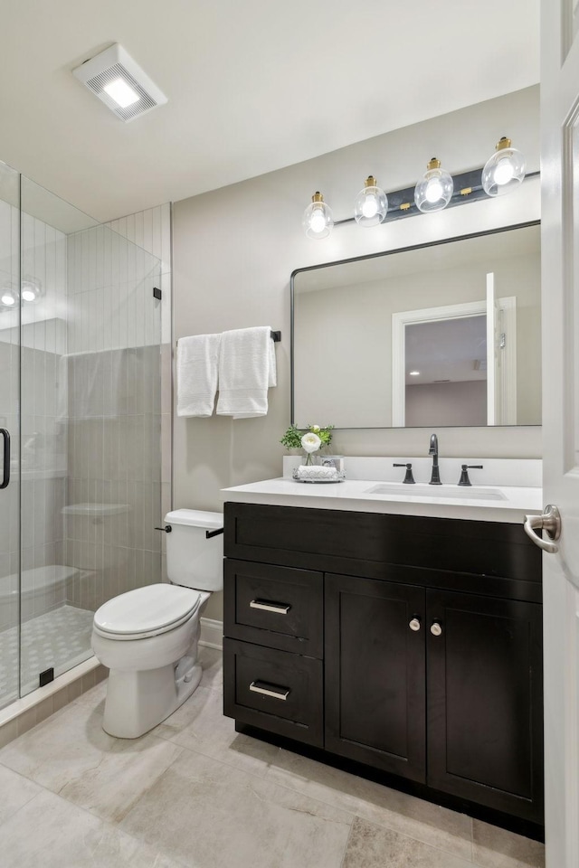 bathroom with vanity, toilet, and walk in shower