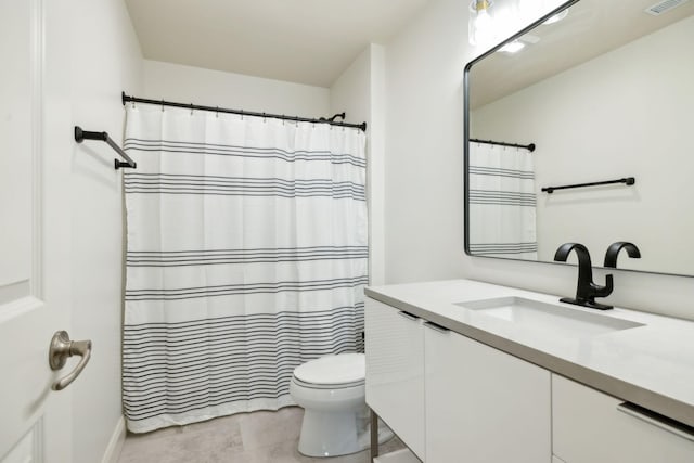 bathroom with tile patterned flooring, vanity, and toilet