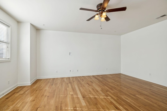 empty room with light hardwood / wood-style flooring and ceiling fan