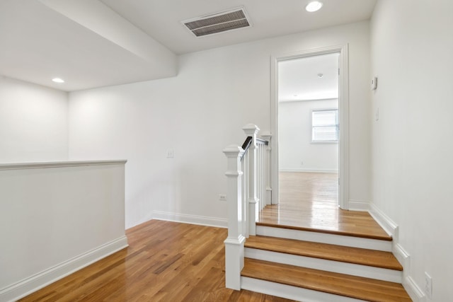 stairs featuring wood-type flooring