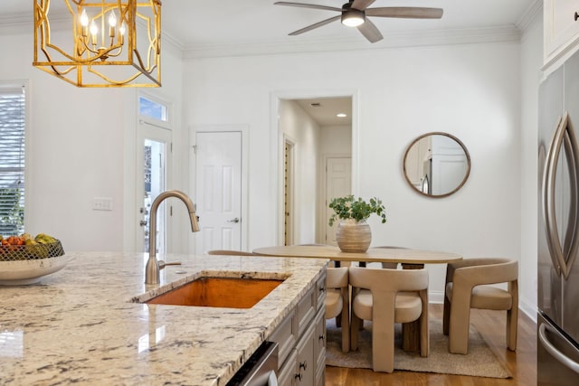 kitchen with pendant lighting, plenty of natural light, stainless steel appliances, and sink