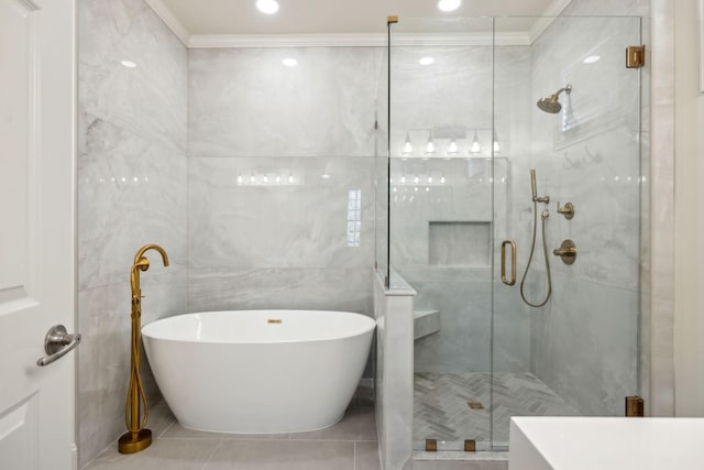 bathroom featuring independent shower and bath, ornamental molding, tile patterned flooring, and tile walls